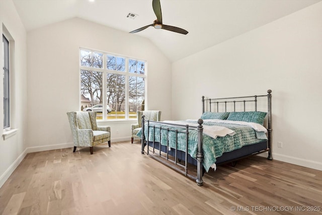 bedroom featuring hardwood / wood-style flooring, lofted ceiling, and ceiling fan