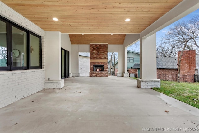 view of patio / terrace featuring an outdoor brick fireplace