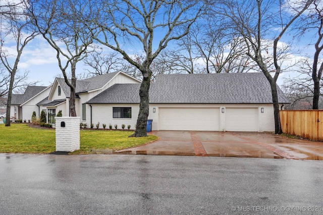 view of front of property featuring a garage and a front lawn