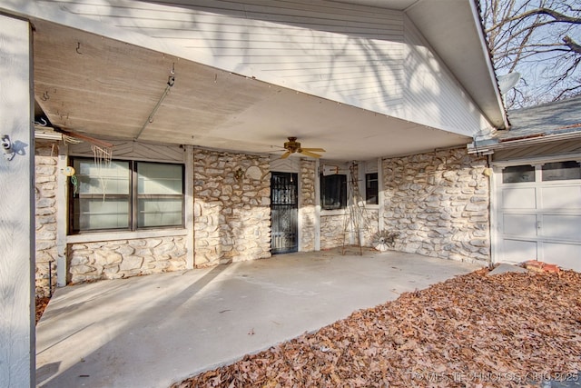 view of patio with a garage and ceiling fan