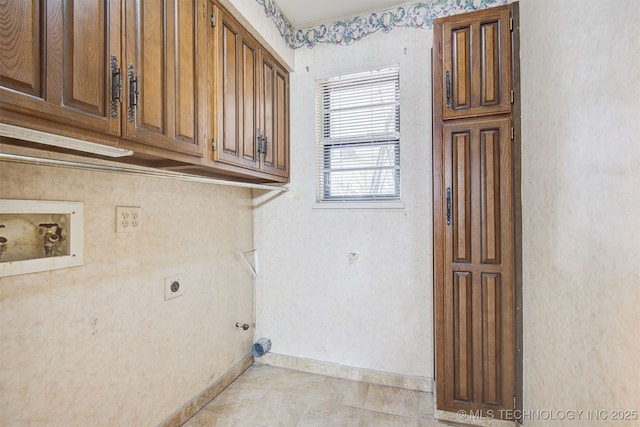 washroom featuring cabinets, light tile patterned flooring, washer hookup, and hookup for an electric dryer