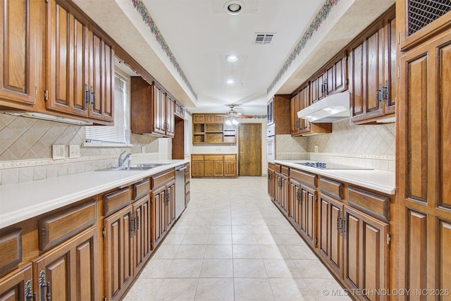 kitchen with light tile patterned flooring, sink, stainless steel dishwasher, ceiling fan, and backsplash