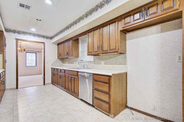 kitchen featuring light carpet, sink, stainless steel dishwasher, and backsplash