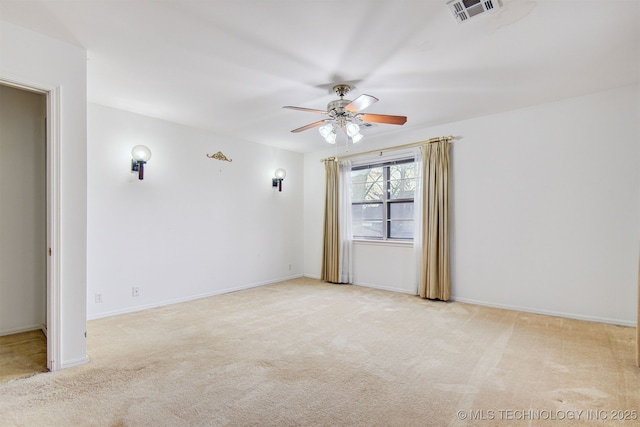 empty room featuring light carpet and ceiling fan