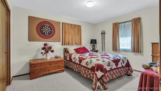 carpeted bedroom featuring a textured ceiling