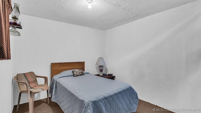 carpeted bedroom featuring a textured ceiling