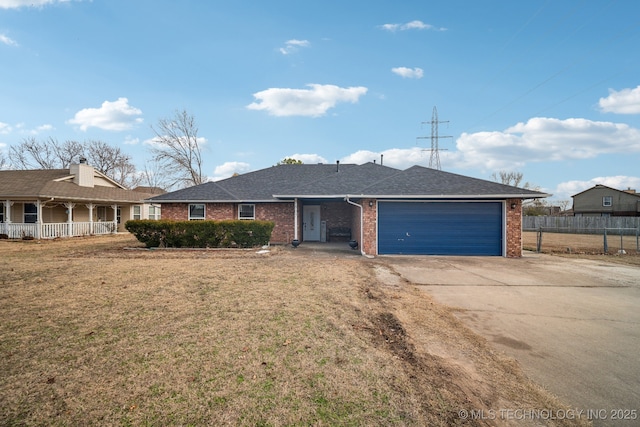 ranch-style house with a garage and a front yard