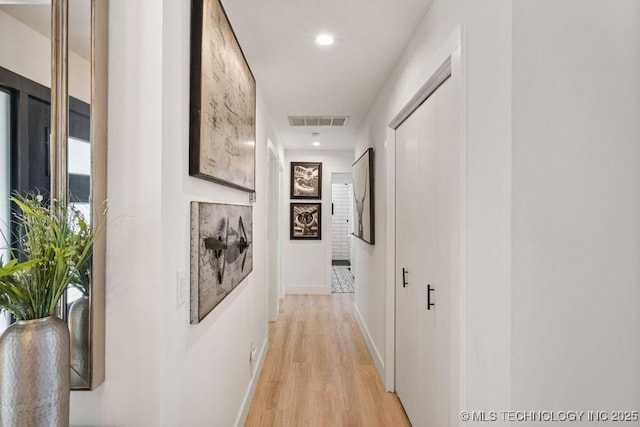 hall with light hardwood / wood-style floors