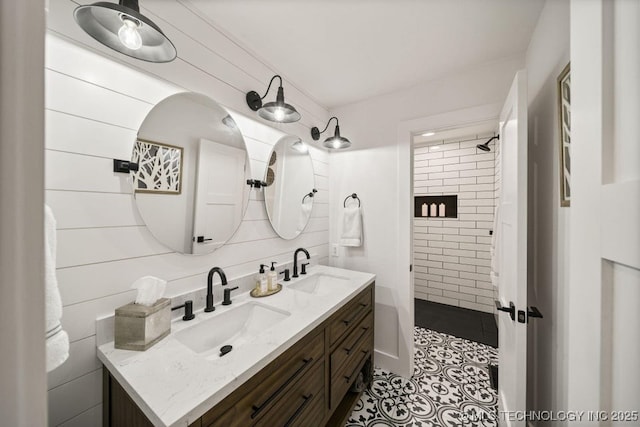 bathroom with vanity and a tile shower