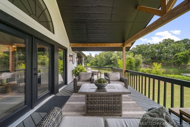 wooden deck with outdoor lounge area and a lawn