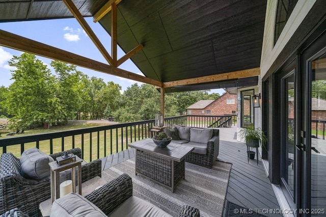 wooden deck featuring a yard and outdoor lounge area