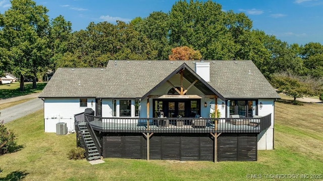 back of house with a wooden deck, cooling unit, and a lawn