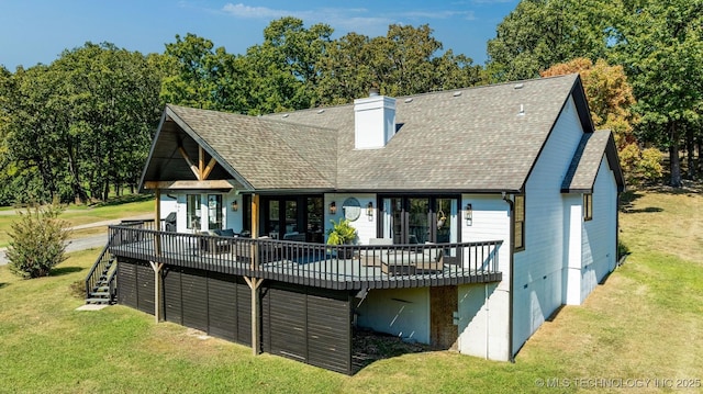 rear view of house featuring french doors, a yard, and a deck