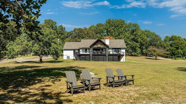 exterior space featuring a wooden deck and a lawn