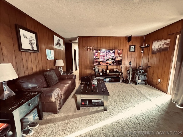 carpeted home theater with a textured ceiling and wood walls