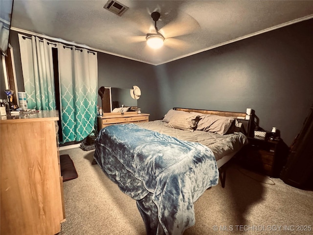 bedroom with ornamental molding, carpet, a textured ceiling, and ceiling fan