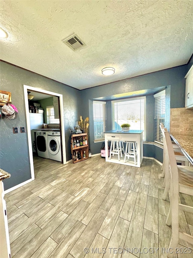 interior space with washer and dryer and a textured ceiling