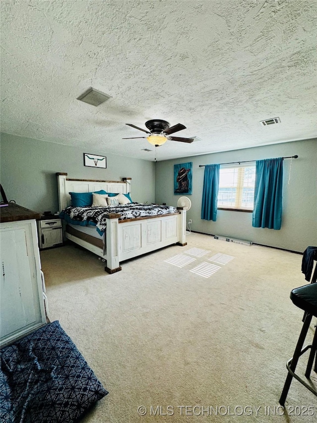 bedroom featuring carpet floors, a textured ceiling, and ceiling fan