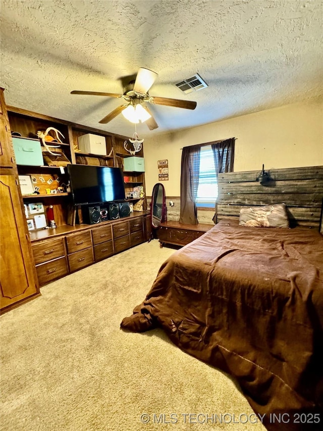 bedroom featuring ceiling fan, carpet flooring, and a textured ceiling