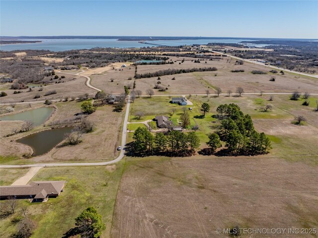 birds eye view of property featuring a rural view and a water view