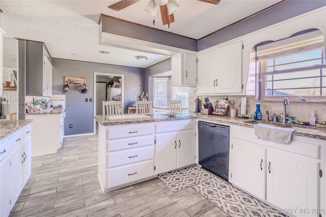 kitchen with black dishwasher, decorative backsplash, a peninsula, white cabinets, and a sink