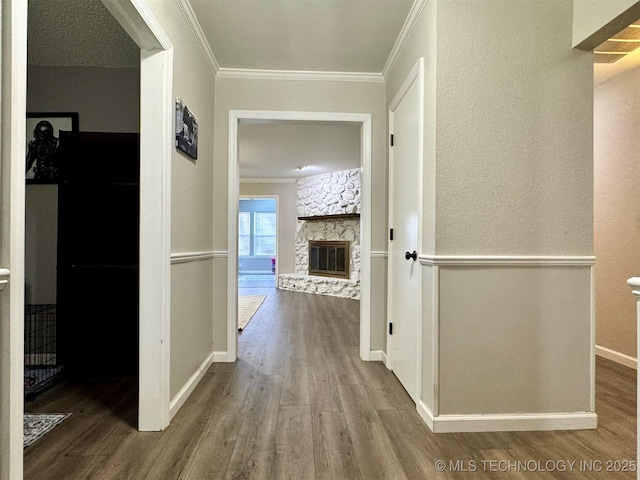 corridor featuring crown molding and hardwood / wood-style flooring