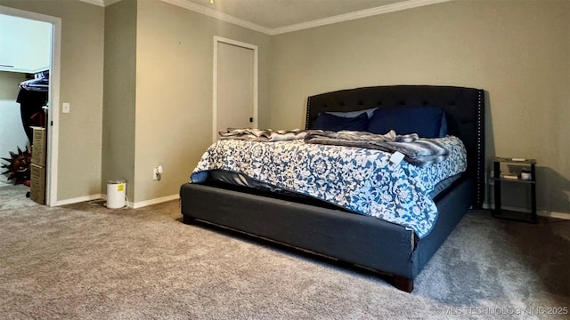 carpeted bedroom featuring ornamental molding and a walk in closet