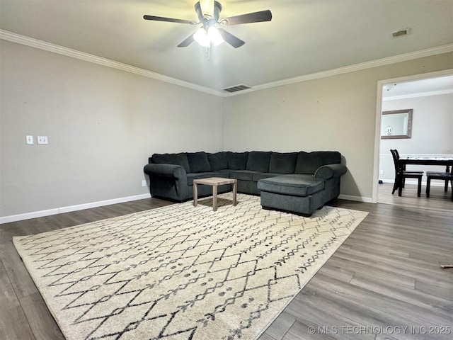 living room with dark hardwood / wood-style flooring, ornamental molding, and ceiling fan