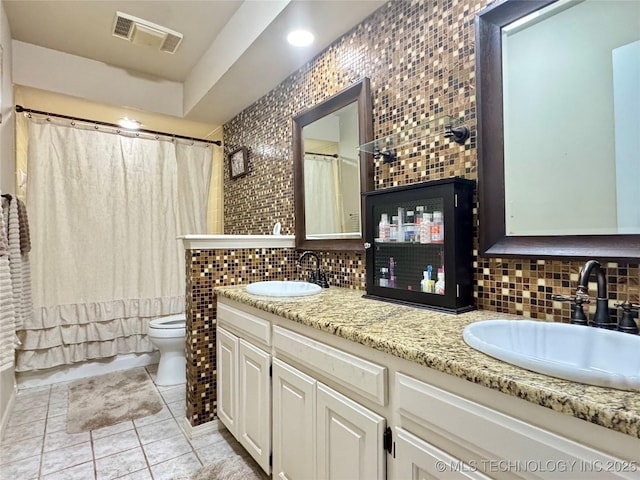 full bathroom with vanity, toilet, tile patterned flooring, and decorative backsplash