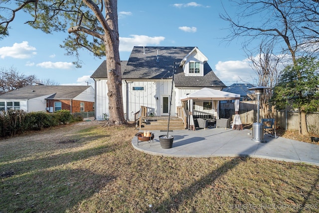 rear view of house with a gazebo, a lawn, and a patio