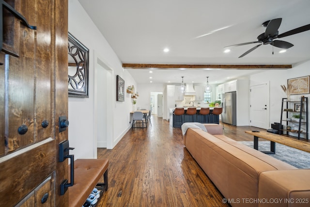 living room with beamed ceiling, ceiling fan, and dark hardwood / wood-style flooring