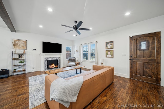 living room with beamed ceiling, ceiling fan, and dark hardwood / wood-style floors