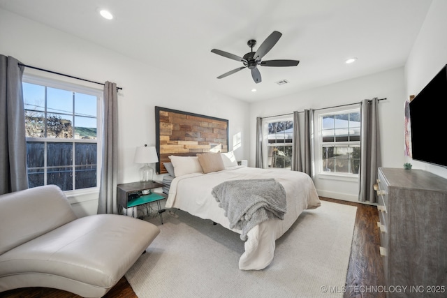 bedroom with dark hardwood / wood-style floors and ceiling fan