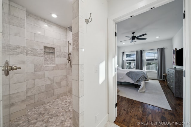 bathroom featuring tiled shower, hardwood / wood-style floors, and ceiling fan