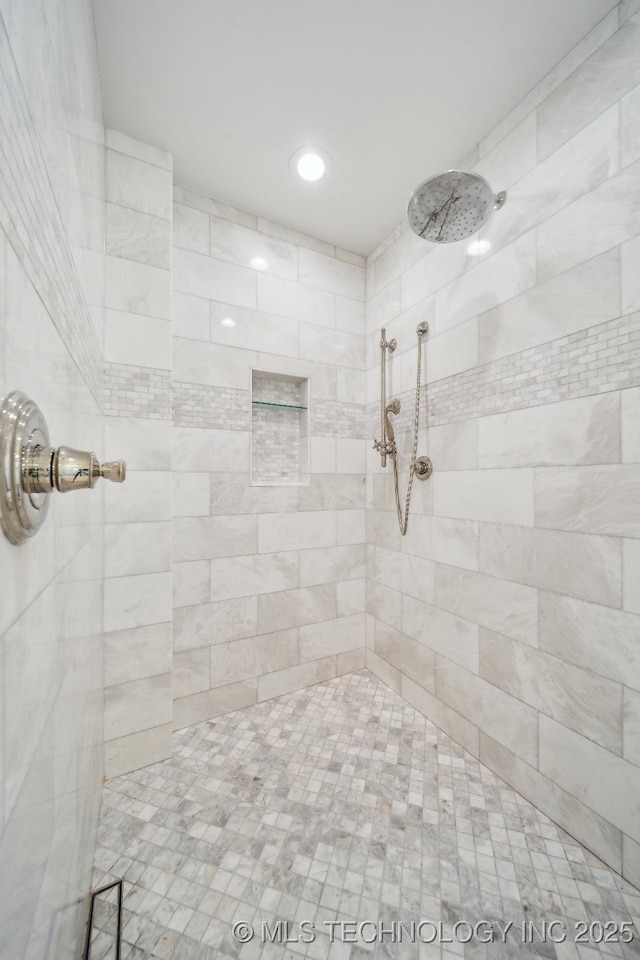 bathroom with a tile shower