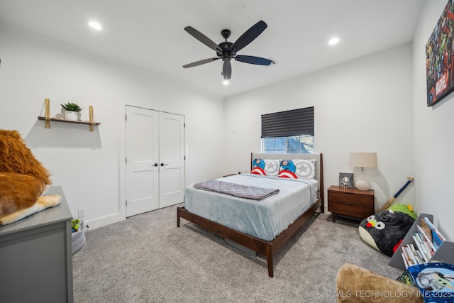 carpeted bedroom featuring ceiling fan and a closet