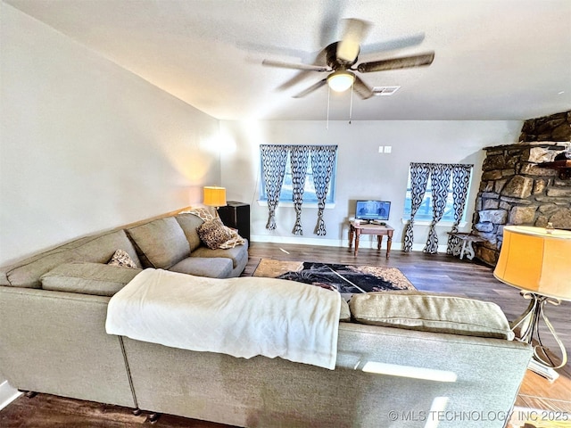 living area featuring ceiling fan, wood finished floors, and visible vents