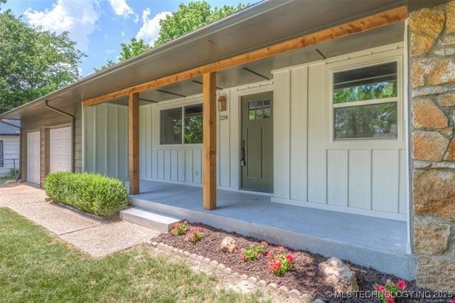 property entrance featuring a garage and covered porch