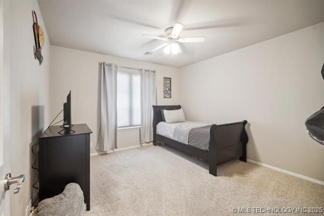 bedroom featuring light colored carpet and ceiling fan