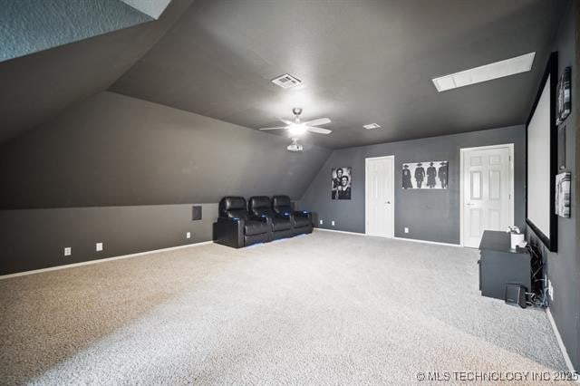 carpeted cinema room featuring lofted ceiling and ceiling fan