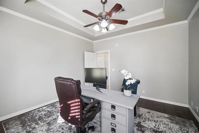 office area featuring a raised ceiling, ornamental molding, and ceiling fan