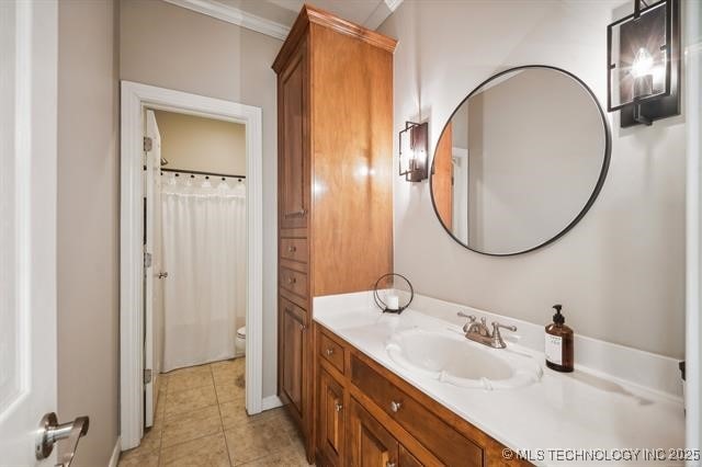 bathroom featuring tile patterned flooring, ornamental molding, vanity, walk in shower, and toilet