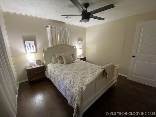 bedroom with ornamental molding, dark wood-type flooring, a textured ceiling, and ceiling fan