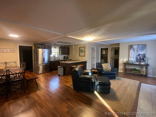 living room featuring dark hardwood / wood-style flooring and a textured ceiling