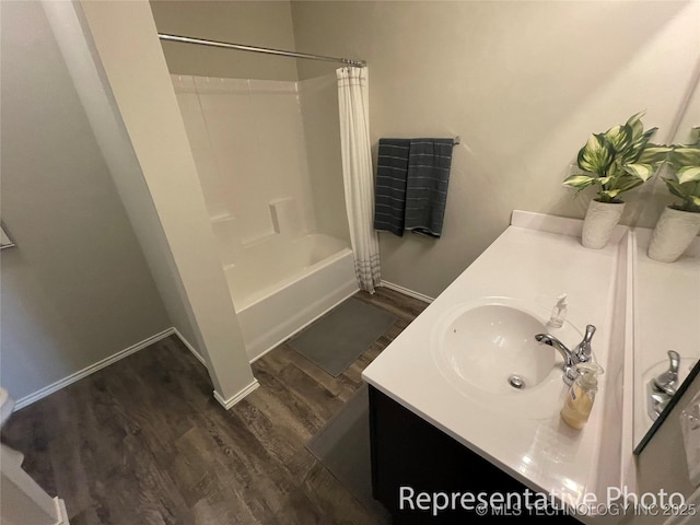 bathroom with hardwood / wood-style flooring, vanity, and shower / bath combo with shower curtain