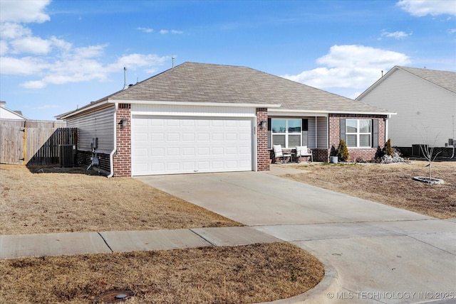 ranch-style home featuring a garage and central AC