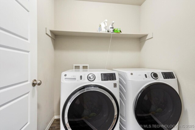 laundry room featuring dark wood-type flooring and separate washer and dryer