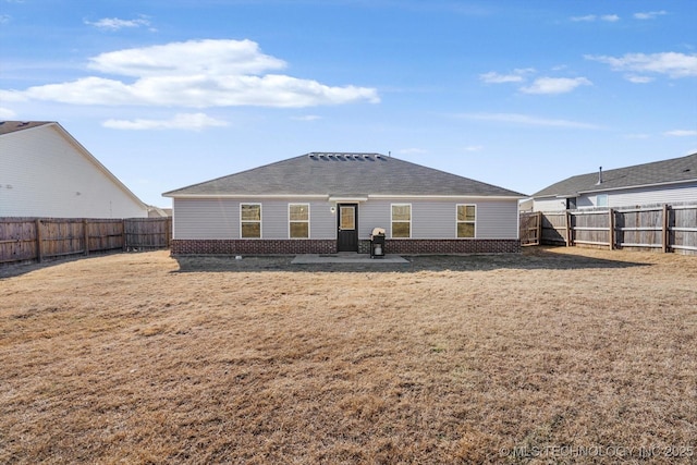 back of house with a patio and a lawn