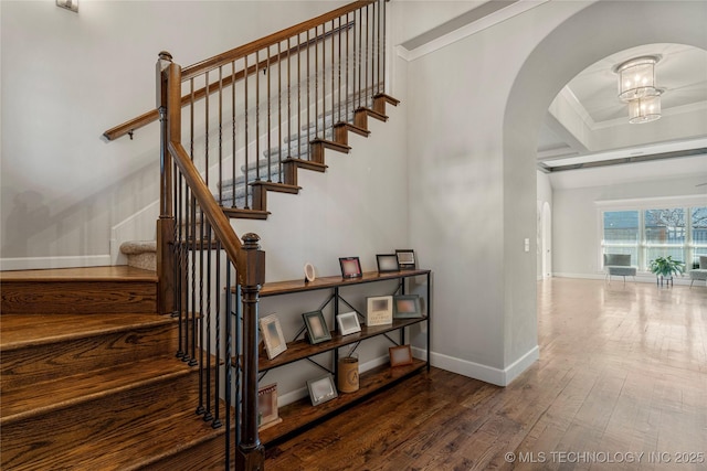 staircase with wood-type flooring, coffered ceiling, and beam ceiling