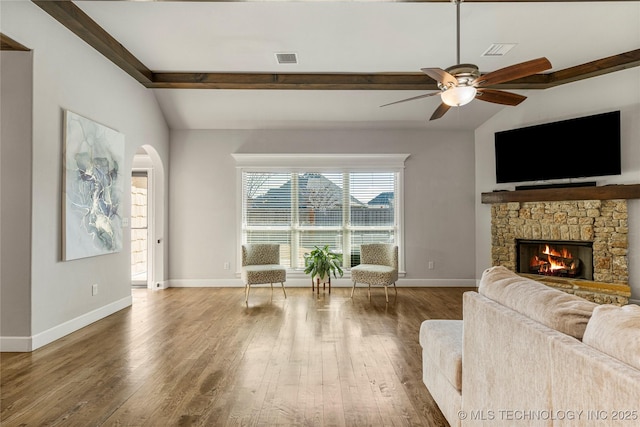 living room featuring lofted ceiling with beams, ceiling fan, a fireplace, and hardwood / wood-style floors